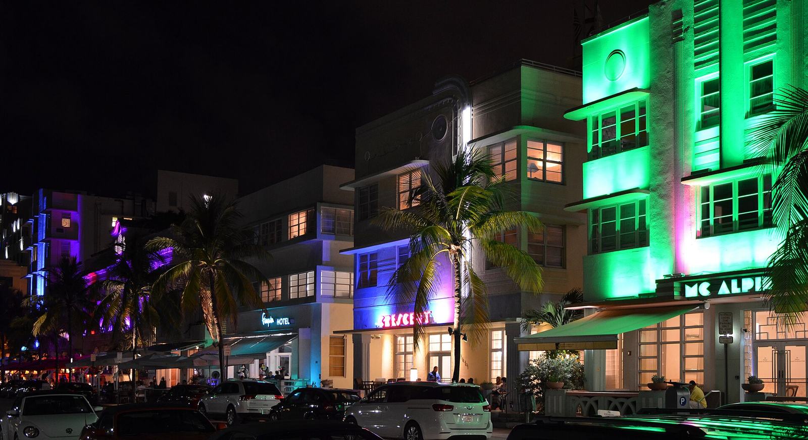 Ocean Drive hotels glowing with neon at night in Miami Beach